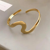 Classic open bangle with golden wave